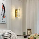 Living room interior with wall sconce, framed artwork, and decorative items.